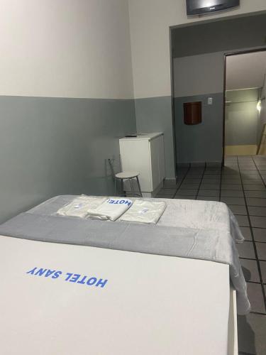 a hospital room with a bed with towels on it at Hotel Sany SP- Metrô Paulista in Sao Paulo