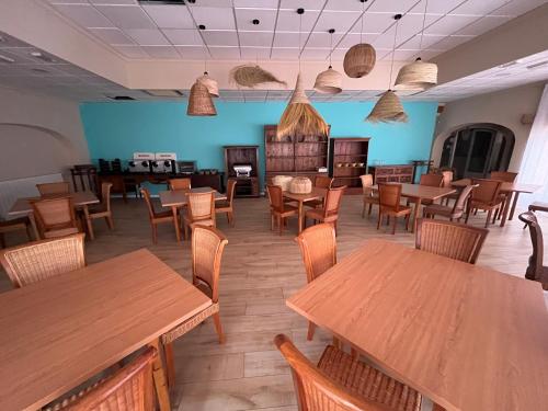 a dining room with wooden tables and chairs at Aparthotel Bahia Pinosol in Jávea