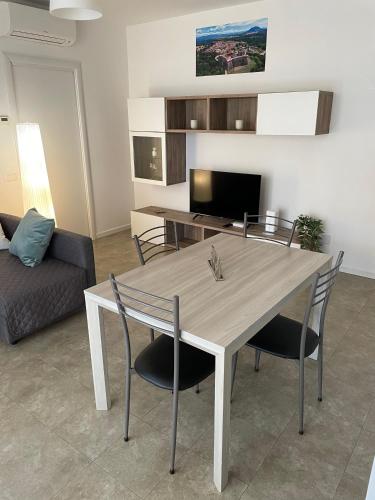 a living room with a table and chairs and a couch at Casa Vacanze Anna in Civita Castellana