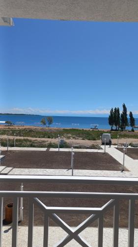 a bench on a beach with the ocean in the background at Shaika resort Bibllan apartmens in Chon-Sary-Oy