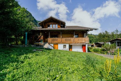 a house on top of a grassy hill at Mountain View near Brienz - free parking in Kienholz