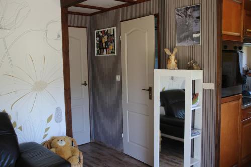a living room with a door open to a kitchen at Chalet du Lièvre in Hannappes