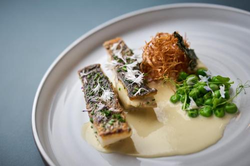a white plate with food on a table at Villa Badi in Umag