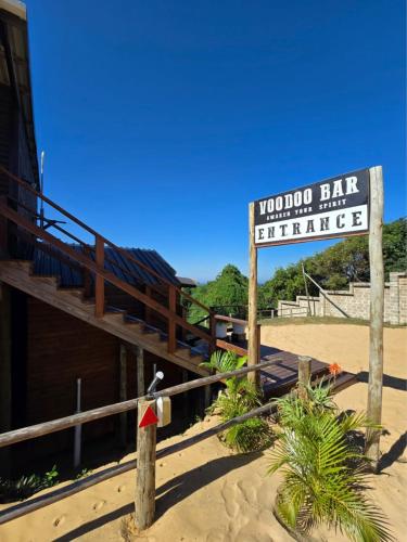 a sign for a hotel on the beach at Sunrise Beach Lodge in Ponta Malongane
