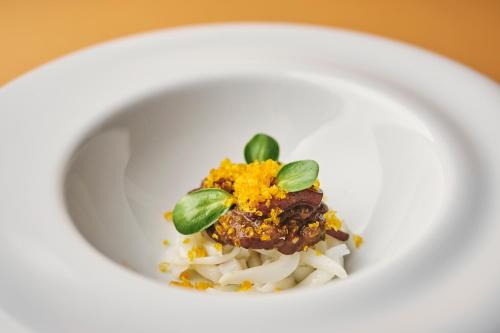 a white plate with food on top of white rice at Villa Badi in Umag