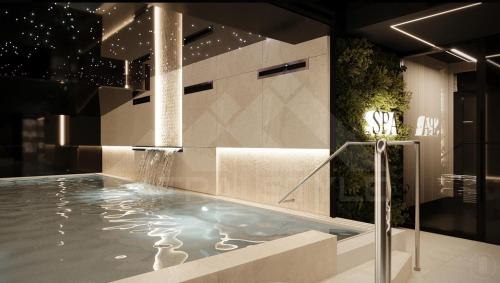 a bathroom with a swimming pool with a fountain at Apartament INCOGNITO PREMIUM & SPA in Białka Tatrzanska