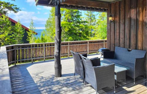 a deck with chairs and a table on a porch at 2 Bedroom Nice Home In Hafjell in Hafjell