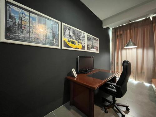 a office with a desk with a computer and a chair at Comfy Empire Damansara Studio in Petaling Jaya