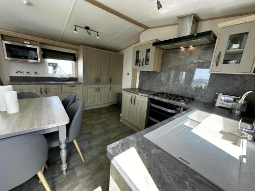 a kitchen with white cabinets and a counter top at Rockley Park Private Holiday Homes in Poole