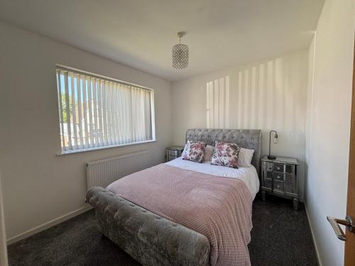 a bedroom with a bed and a window at Thirlmere View Helmshore in Haslingden