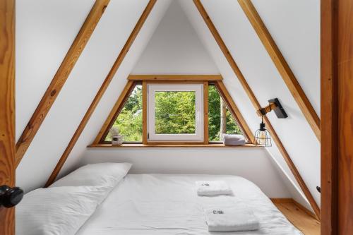 a bed in a room with a window at Kaszuby Lake View in Żuromino