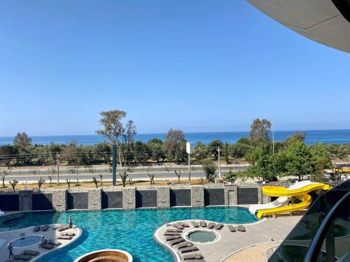 a pool with a water park with a slide at Via Mar Residence - Alanya Experience in Alanya