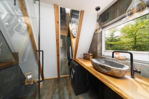 a bathroom with a sink and a window at Kaszuby Lake View in Żuromino