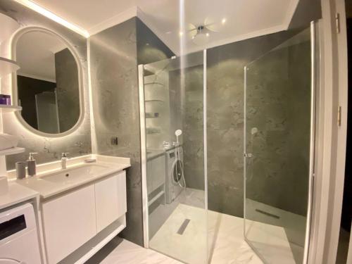 a bathroom with a shower and a sink at Via Mar Residence - Alanya Experience in Alanya