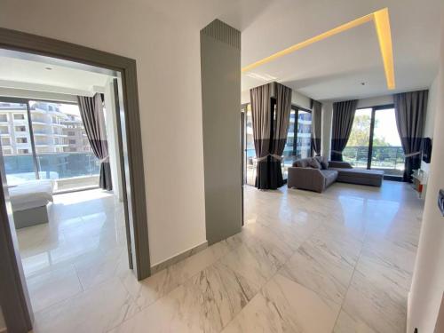 a living room with a couch and a large window at Via Mar Residence - Alanya Experience in Alanya