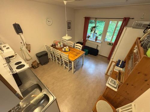 a kitchen and dining room with a table and chairs at Hälsokällans Bed and Breakfast in Kyrkhult