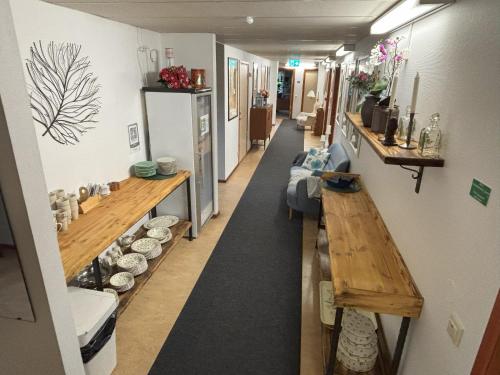 a room with a hallway with a table and a counter at Hälsokällans Bed and Breakfast in Kyrkhult