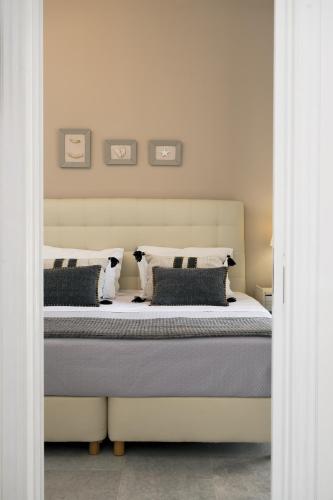 a bedroom with a large bed with two pillows at Scala Apartments in Kastraki Naxou