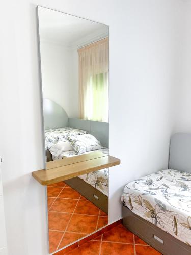 a mirror in a bedroom with two beds at Appart-hôtel Costa Azul - Richa in Oued Laou