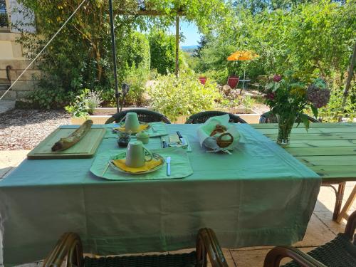 a table with a blue table cloth on it at Presbytère in Marigny-sur-Yonne