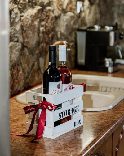 a bottle of wine sitting on top of a counter at Aigli Villa Drepano in Drepana
