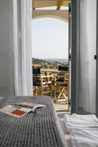 a bedroom with a bed and a view of a patio at Scala Apartments in Kastraki Naxou