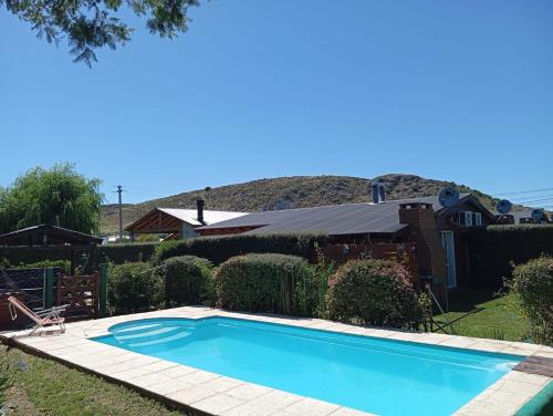 a swimming pool in the yard of a house at Postal del Ceferino in Sierra de la Ventana