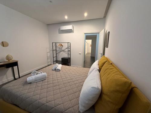 a bedroom with a bed with two towels on it at Borbon Home luxury rooms & SPA in Palermo