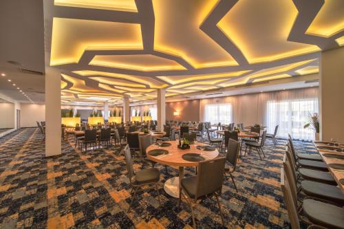 a rendering of a dining room with tables and chairs at Green Garden Hotel in Raszyn