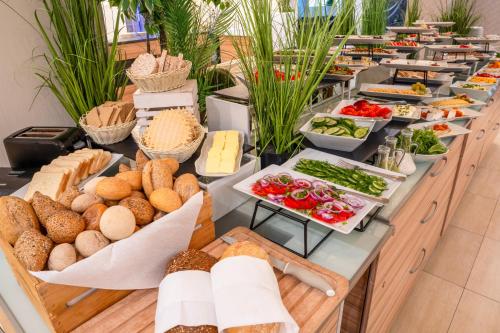a buffet line with different types of food on display at Green Garden Hotel in Raszyn