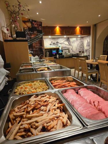 a buffet line with many different types of food at Garden Depandance Am Bach in Kurort Altenberg