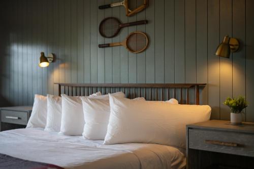 a bedroom with a bed with white pillows at The Woodsman Lodge in Eureka Springs