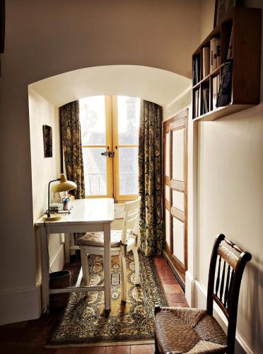 a dining room with a table and a window at La Tour Beurdelaine in Avallon