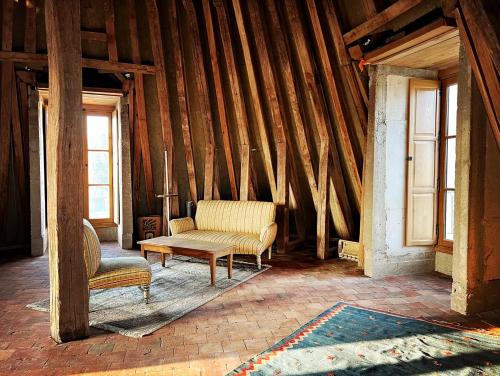 a living room with a couch and a chair at La Tour Beurdelaine in Avallon