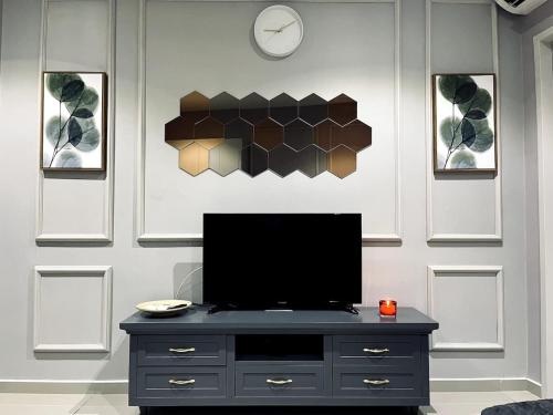 a tv sitting on a dresser in a room at Maple Homes at i-City - WiFi TV Box and 1 Carpark in Shah Alam