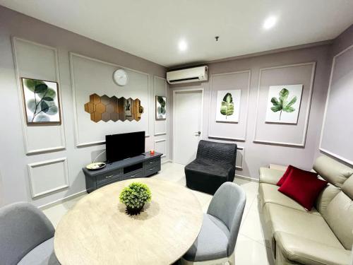 a living room with a table and a couch at Maple Homes at i-City - WiFi TV Box and 1 Carpark in Shah Alam