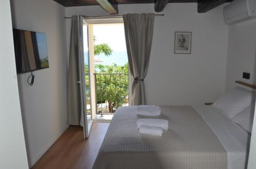 a bedroom with a bed and a sliding glass door at Angelina in Jakišnica