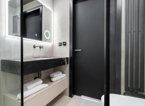 a bathroom with a sink and a mirror at Apartament INCOGNITO PREMIUM & SPA in Białka Tatrzanska