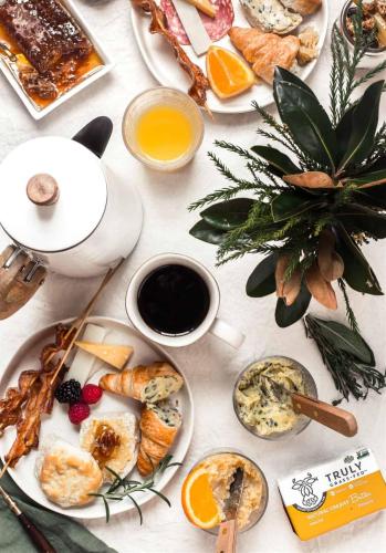 a table topped with plates of food and drinks at THE NIXON Luxury Suites and Apartment Hotel in Athens