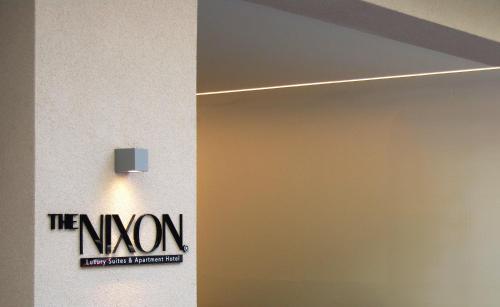a door with the known sign on a wall at THE NIXON Luxury Suites and Apartment Hotel in Athens