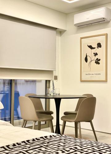 a dining room with a table and chairs at THE NIXON Luxury Suites and Apartment Hotel in Athens