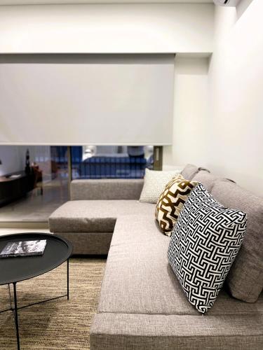a living room with a couch and a table at THE NIXON Luxury Suites and Apartment Hotel in Athens