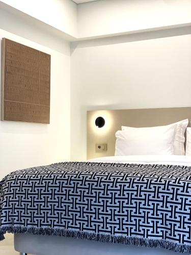 a bedroom with a black and white bed at THE NIXON Luxury Suites and Apartment Hotel in Athens