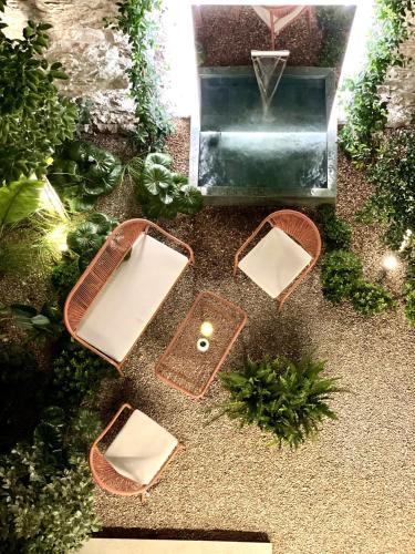 an overhead view of a garden with three baskets and a fountain at THE NIXON Luxury Suites and Apartment Hotel in Athens