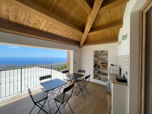 a kitchen and dining room with a view of the ocean at B&B Kalòs experience in Bova