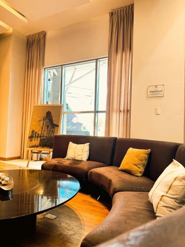 a living room with a couch and a table at Los Silos Hotel in Santa Fe