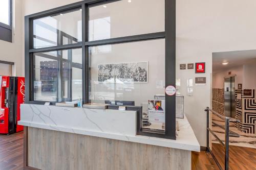 a counter in a store with a large window at Red Roof PLUS Brooklyn - 3rd Ave in Brooklyn
