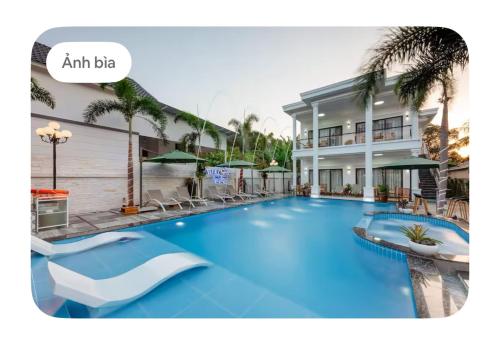 a large blue swimming pool in front of a building at Villa caribe phu quoc in Phu Quoc