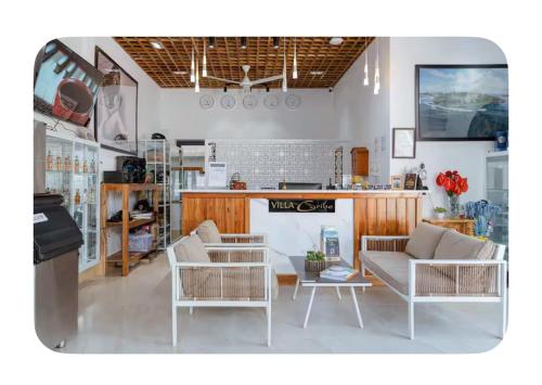 a living room with two couches and a table at Villa caribe phu quoc in Phu Quoc