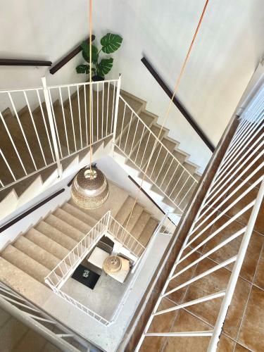 an overhead view of a stairway with a spiral staircase at Urban Hostel Palma - Albergue Juvenil - Youth Hostel in Palma de Mallorca